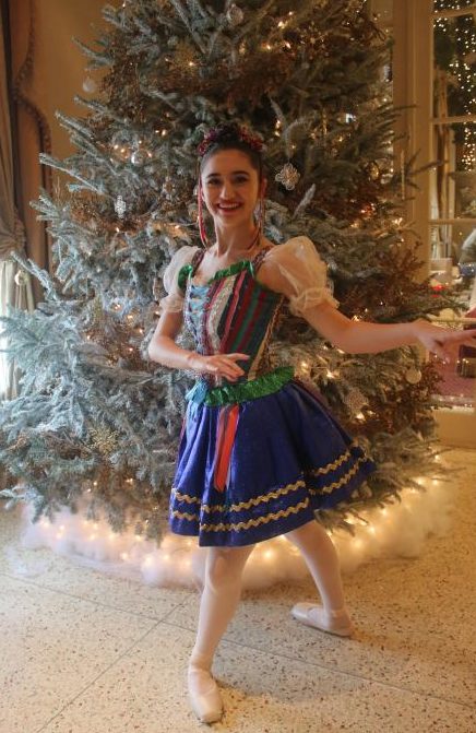 Adrienne Simmons posing next to Christmas tree